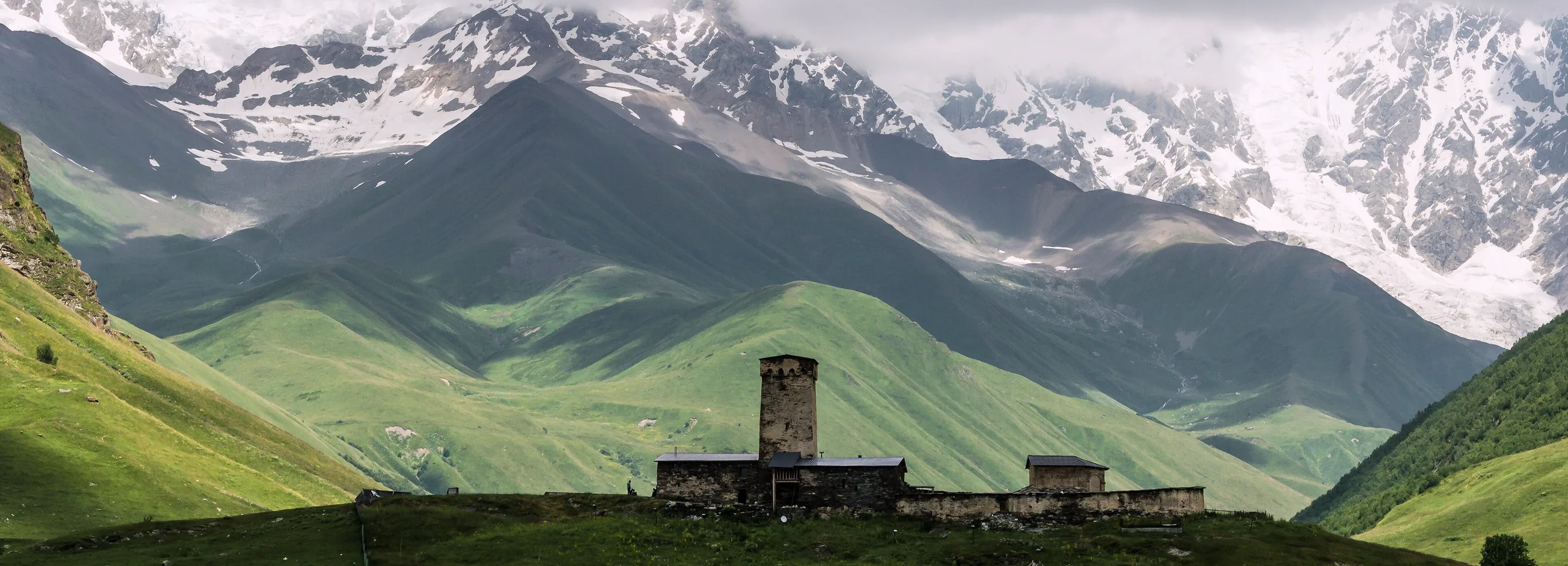 A lone Svan tower at Ushguli under the Shkhara glaciers