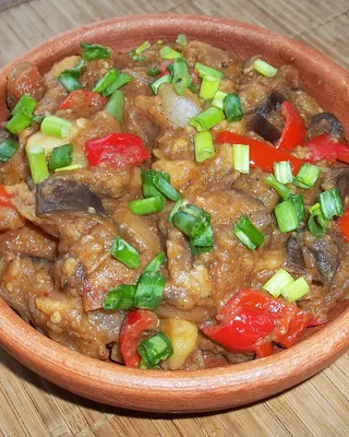 Ajapsandali, a stew of aubergine, pepper and tomato, in a clay bowl with spring onion