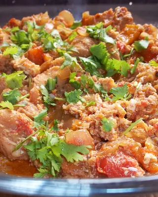 Chakhokhbili, chicken in tomato sauce under fresh coriander