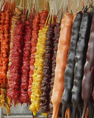 Strands of churchkhela in red, yellow, brown and near black, side by side