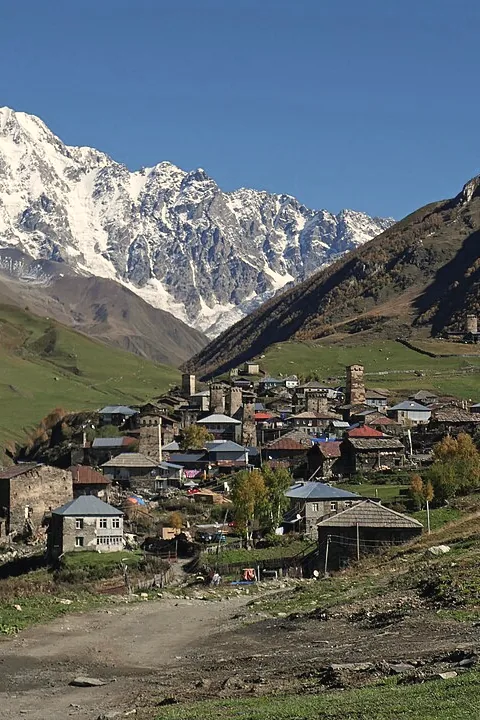 Ushguli in autumn colours under the white wall of Shkhara