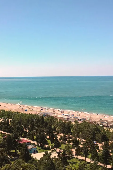 The long beach and boulevard at Batumi from above, turquoise sea in full sun