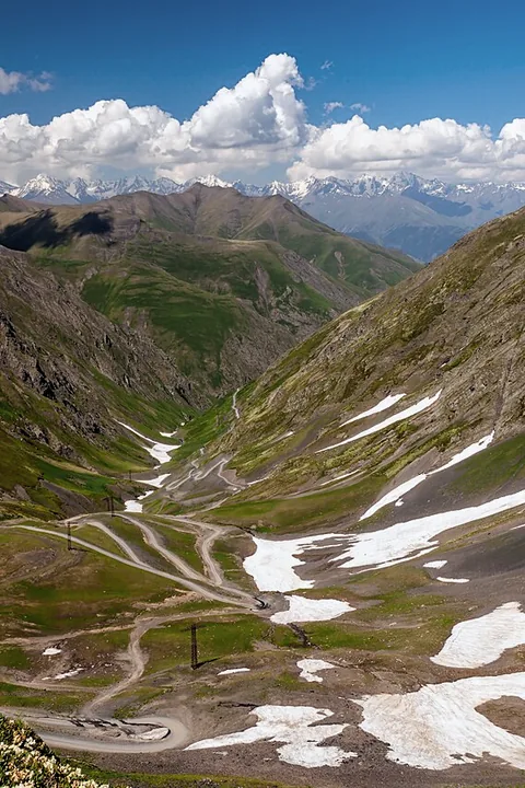 The switchbacks of the Abano pass with snow patches in summer