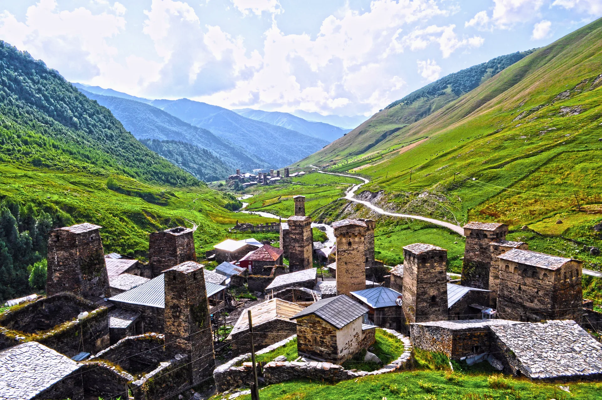 The stone towers of Ushguli in a green valley, Svaneti